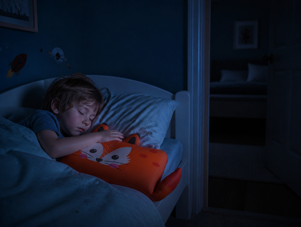 Child asleep in own bed at 2 am holding RYVA fox pillow ear